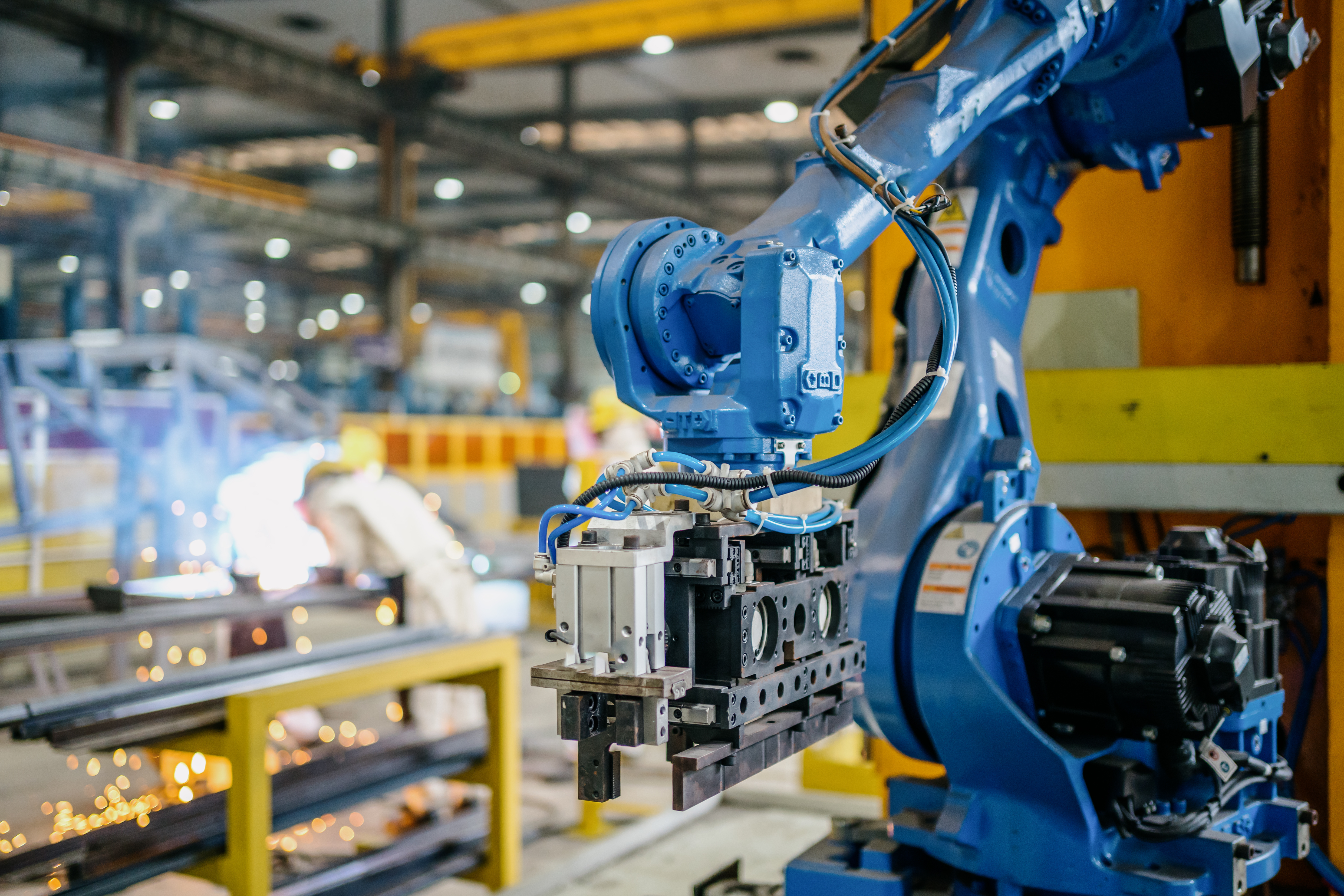 Automated industrial robots operating in a manufacturing facility, representing machinery safety validation and regulatory compliance