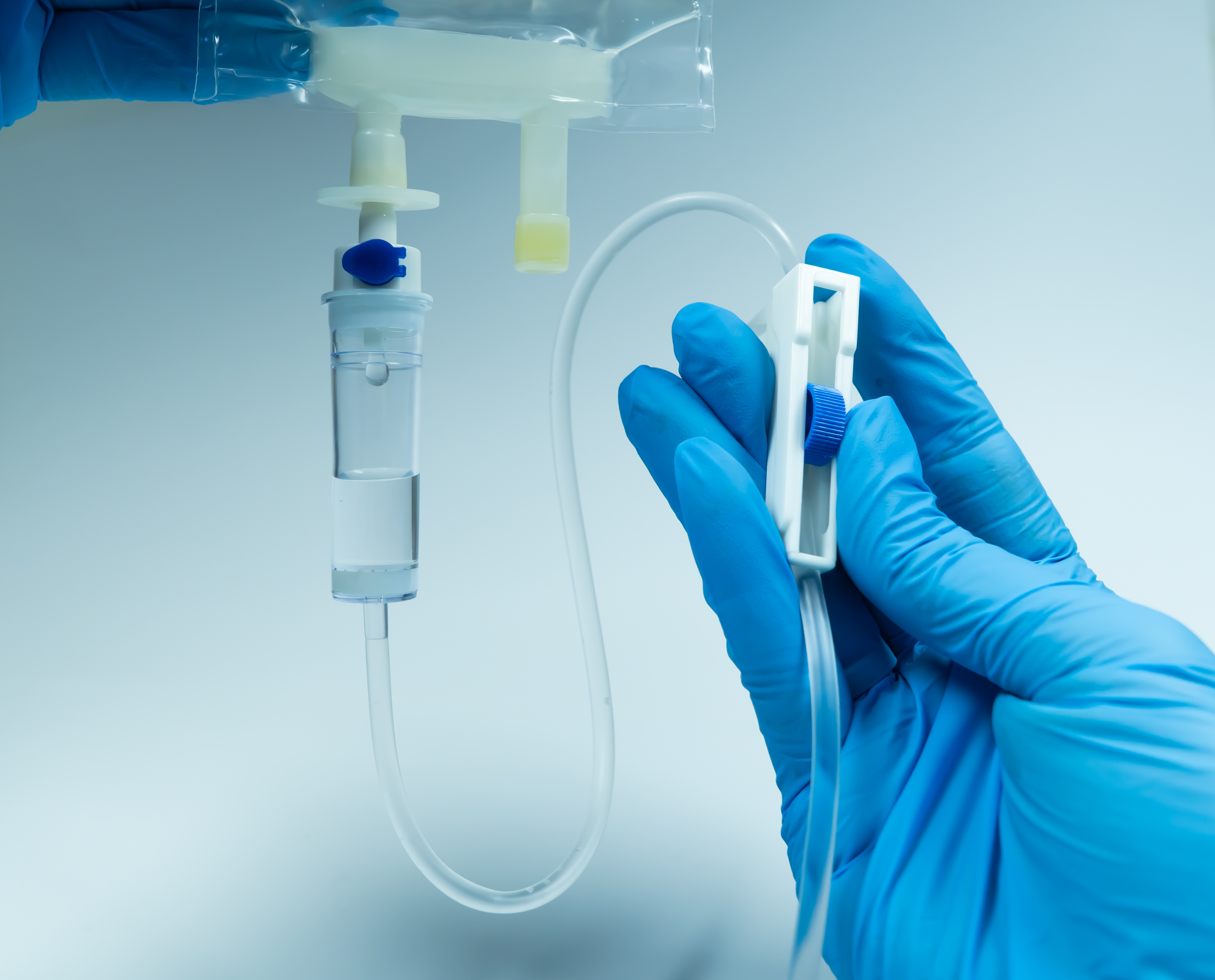 Healthcare professional handling IV medical tubing, illustrating clinical safety, device performance, and MDR conformity assessment requirements.