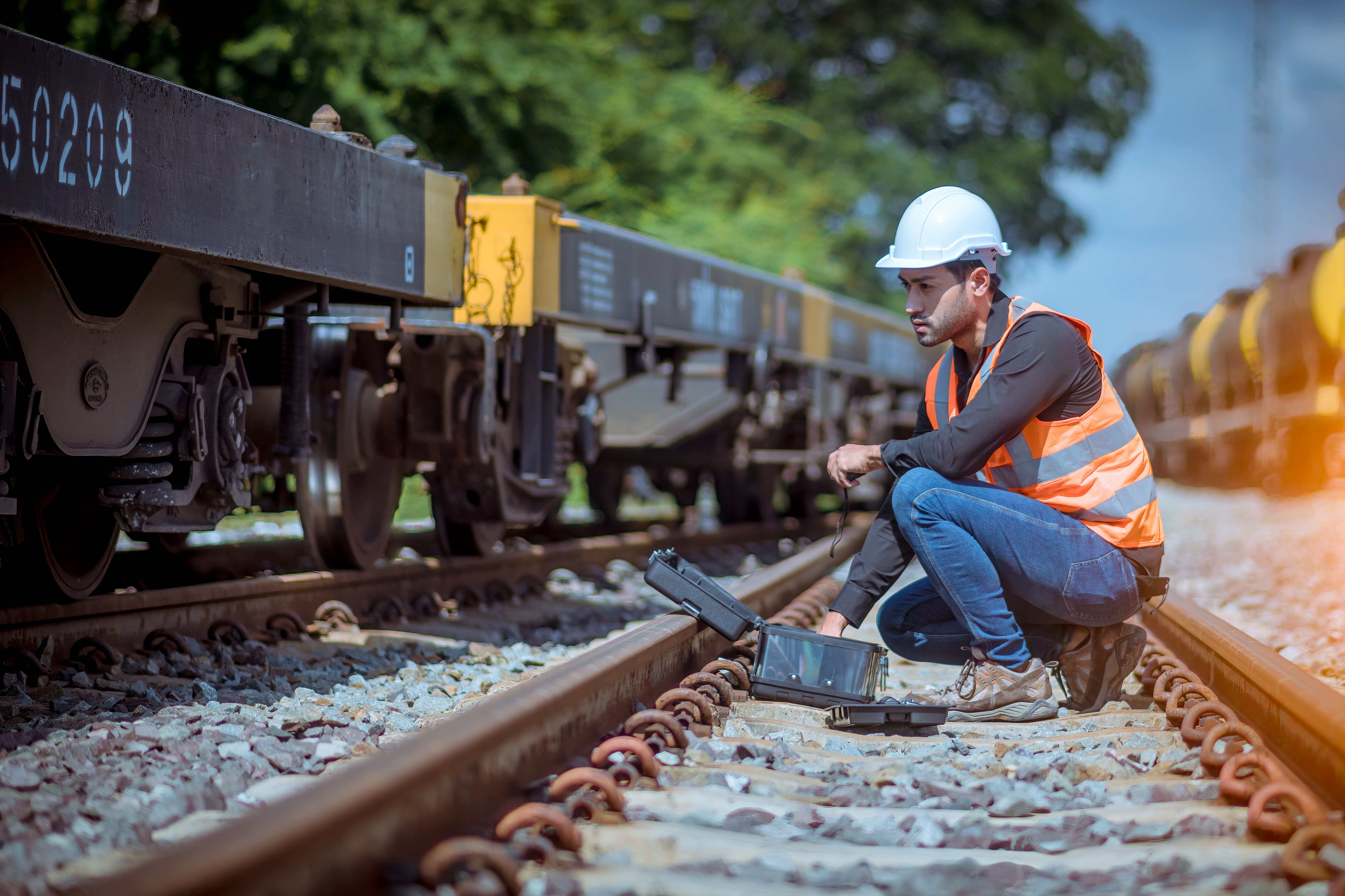 Railway engineer inspecting track components during digital system implementation to ensure safe adoption of new rail technologie