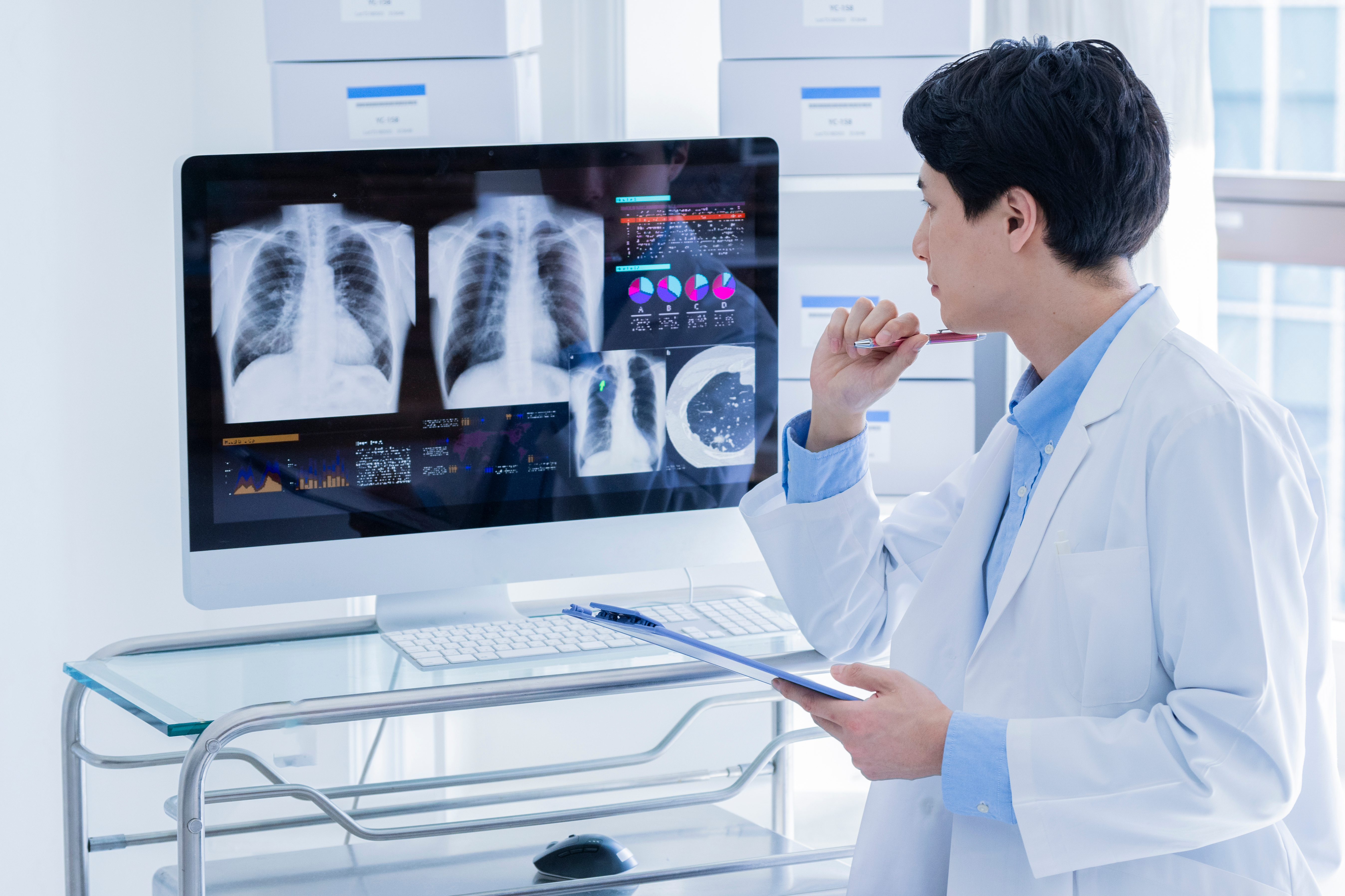 Clinicians analyzing cardiac imaging results in a hospital preparing for DNV VAD credentialing