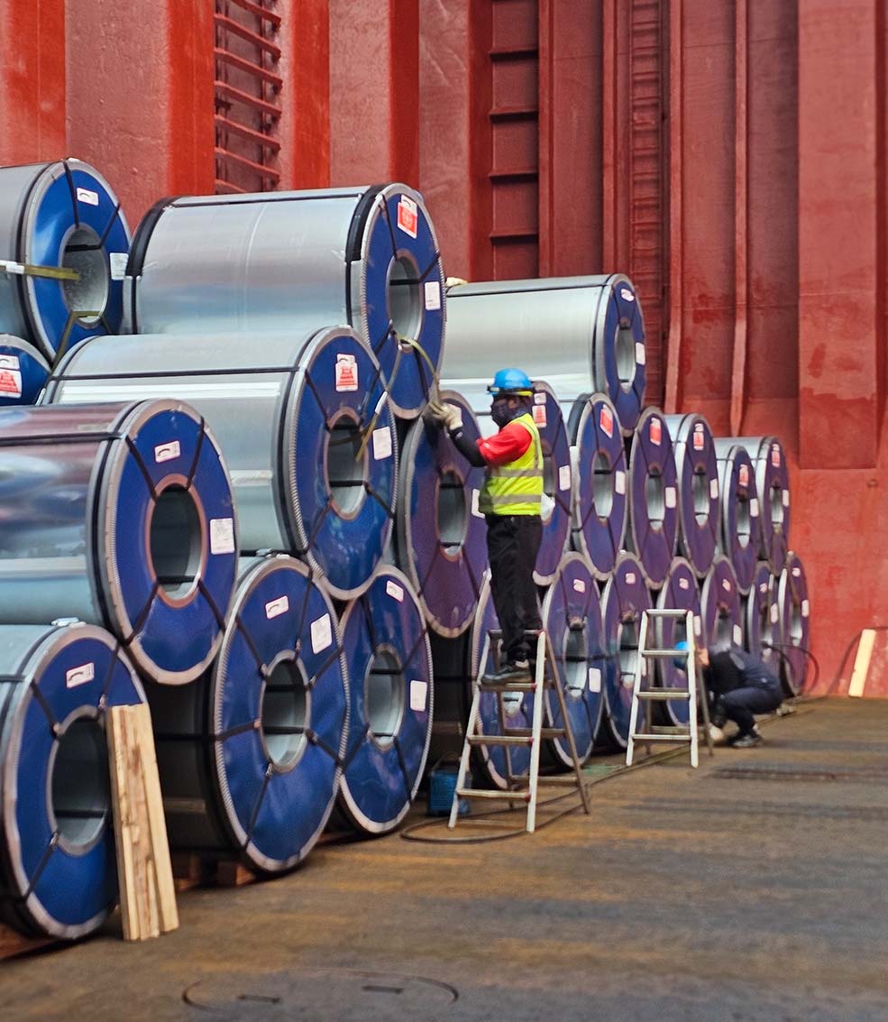 crewman securing steel coils