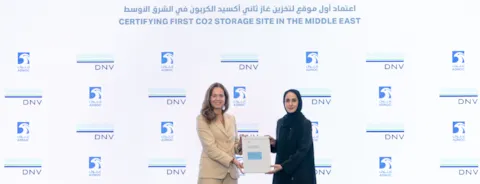 Liv A. Hovem from DNV’s Executive Committee hands the Site Feasibility Certificate to Hanan Balalaa, ADNOC Senior Vice President for New Energies