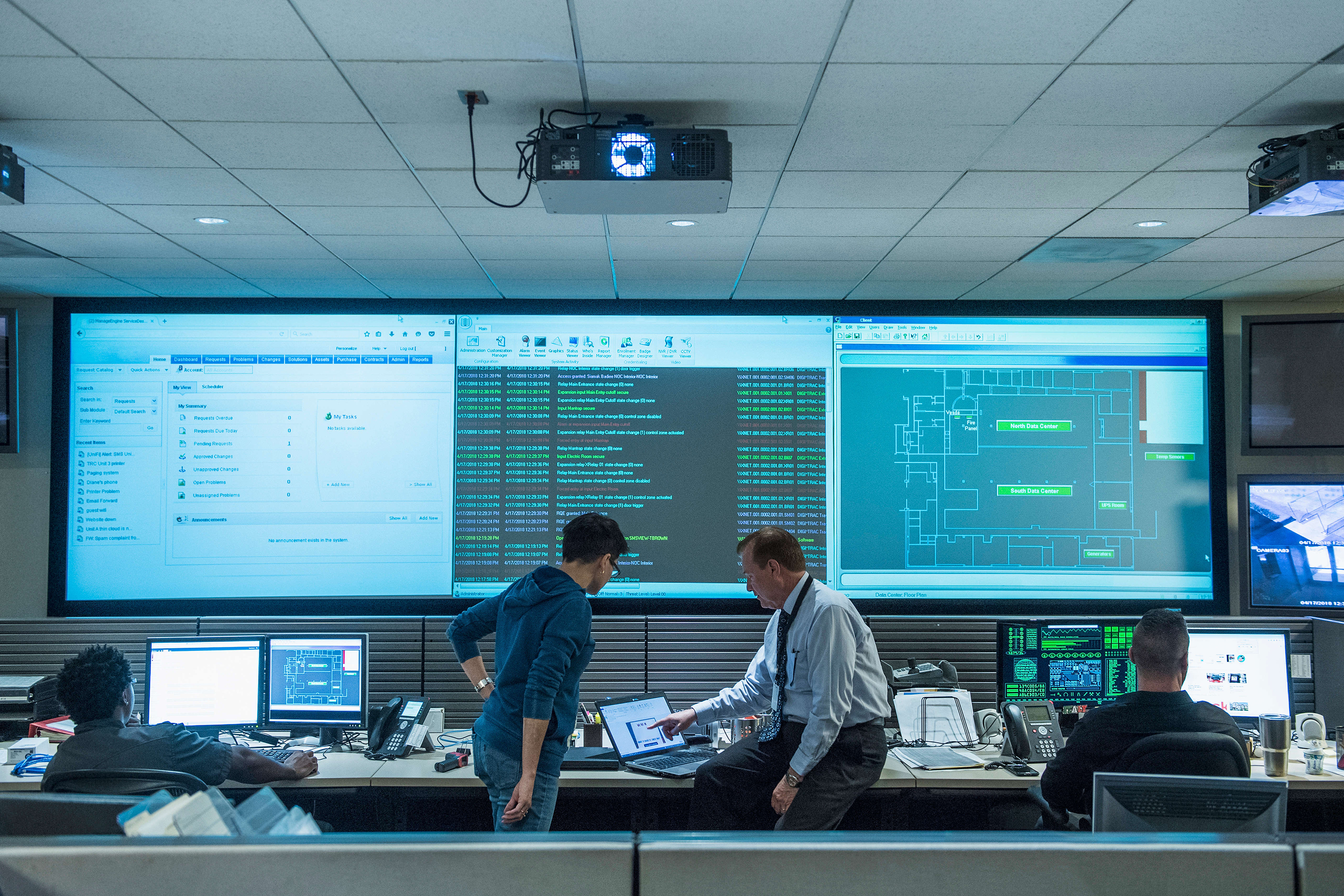 Colleagues working together in a server control room