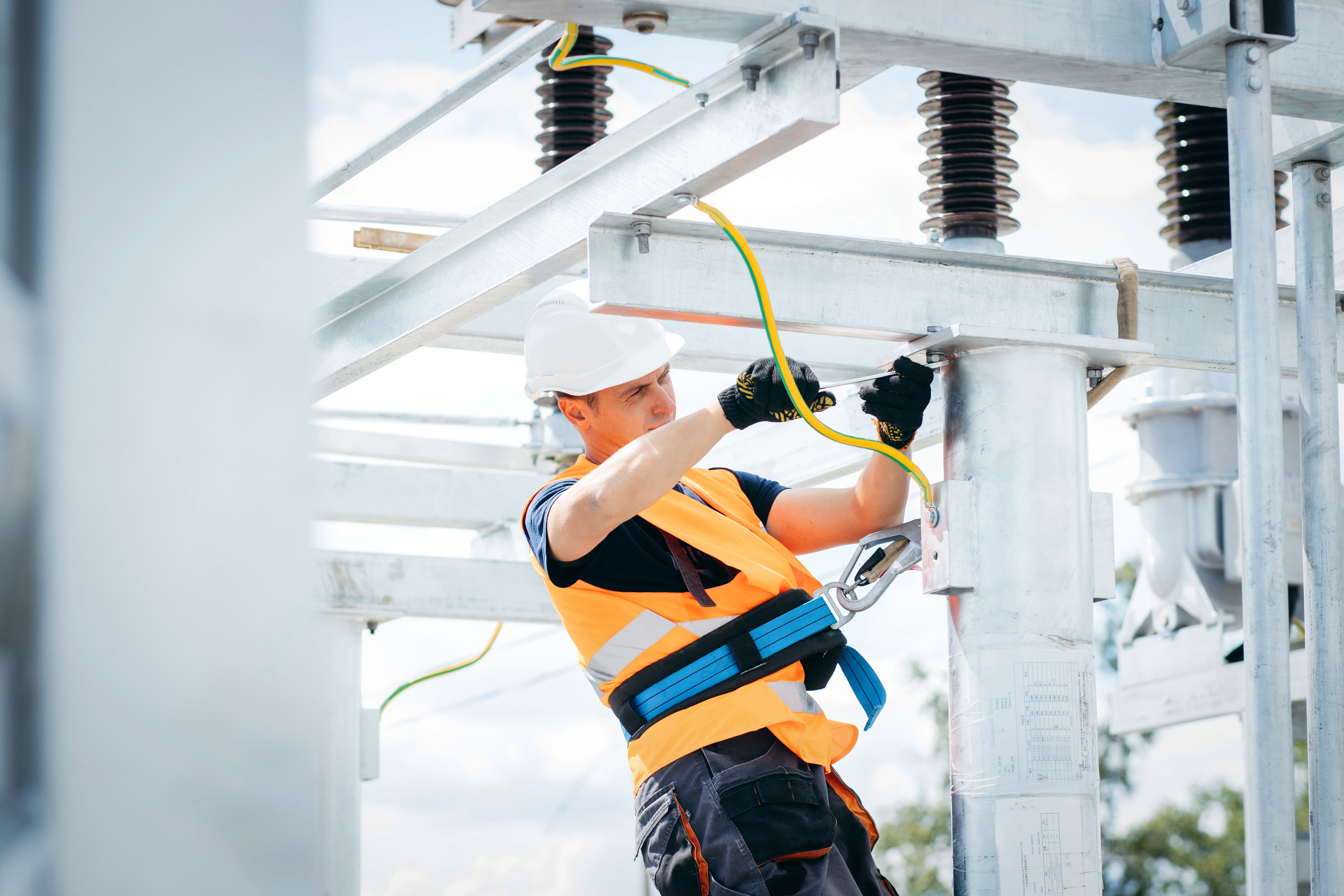 electric grid pylon worker