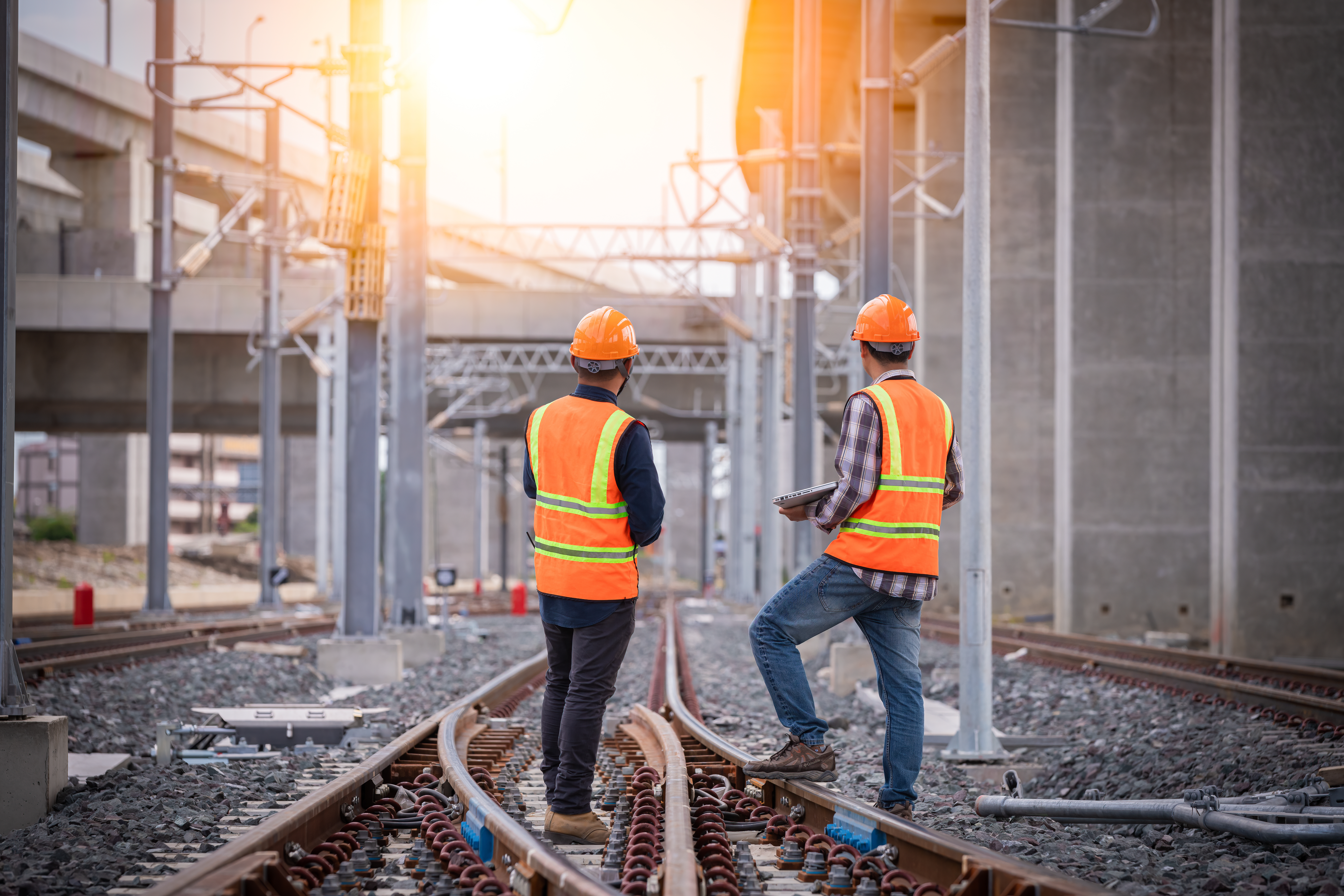 Two rail engineers inspecting railway tracks on site, representing field assessment, safety evaluation, and compliance monitoring