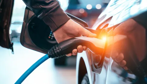 An electric fleet vehicle plugged in to charge