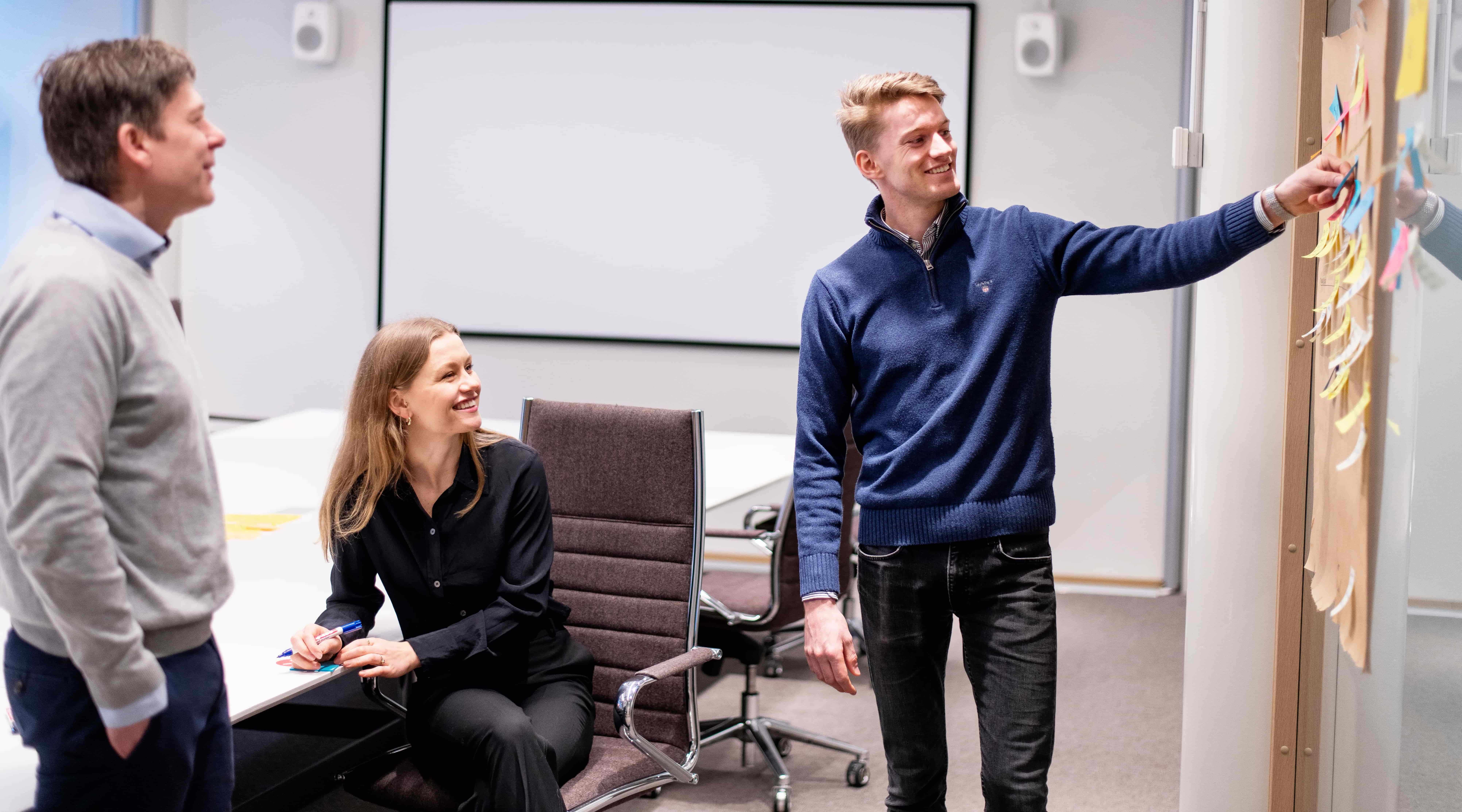 colleagues discussing synergi life qhse software