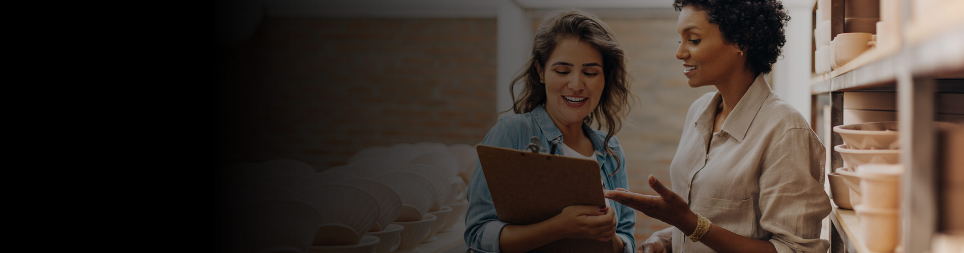 two businesswomen talking with clipboard about energy efficiency