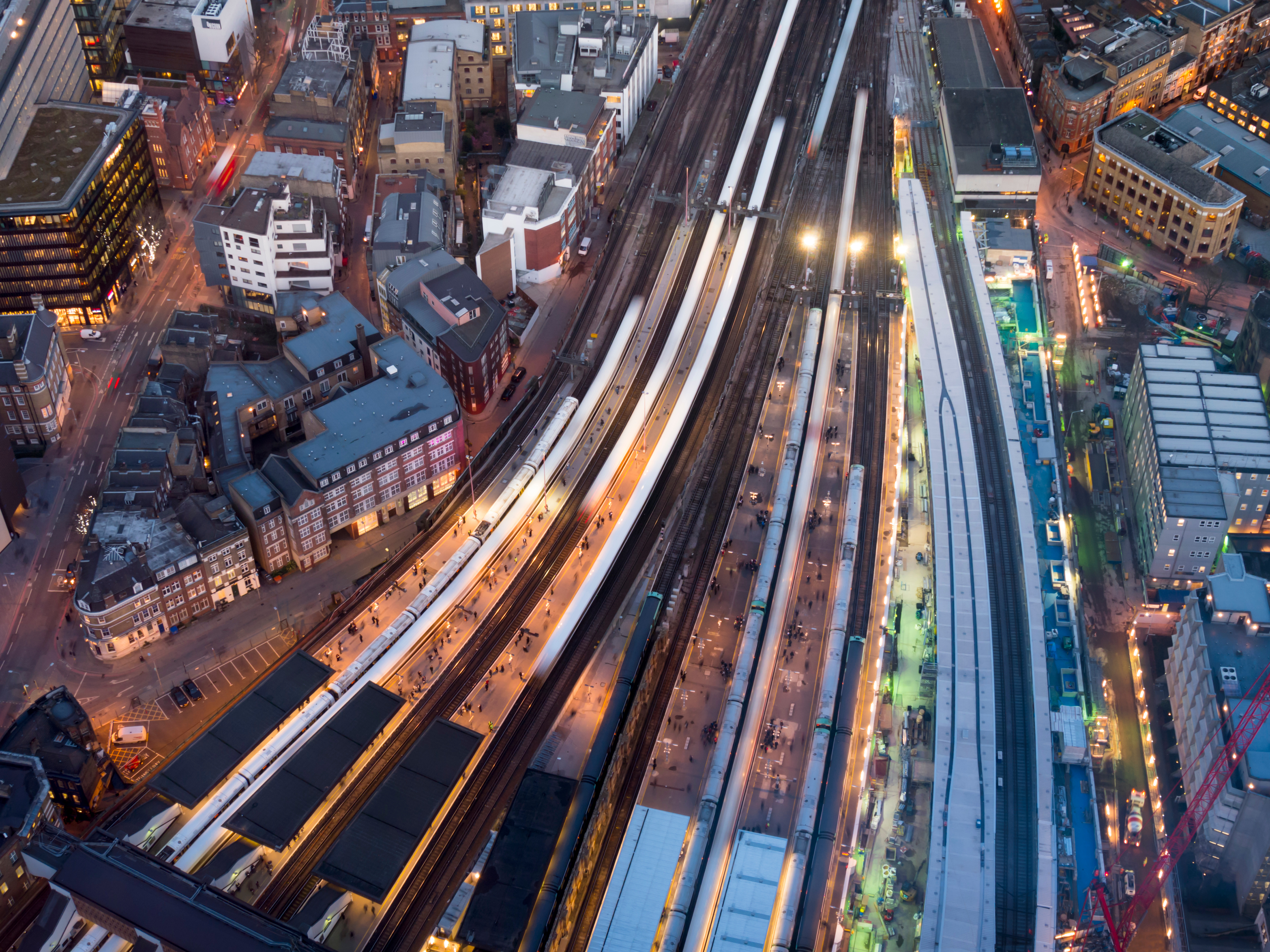Aerial view of railway tracks and trains in an urban setting illustrating complex rail infrastructure