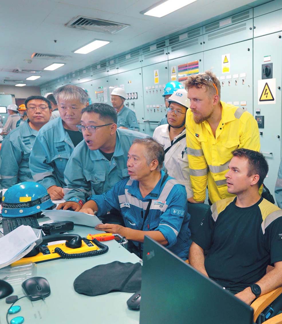 Crew and surveyors in ship control room