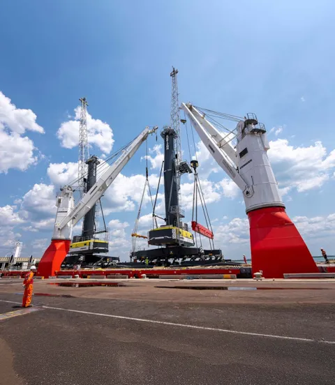 Cranes lifting heavy loads on board