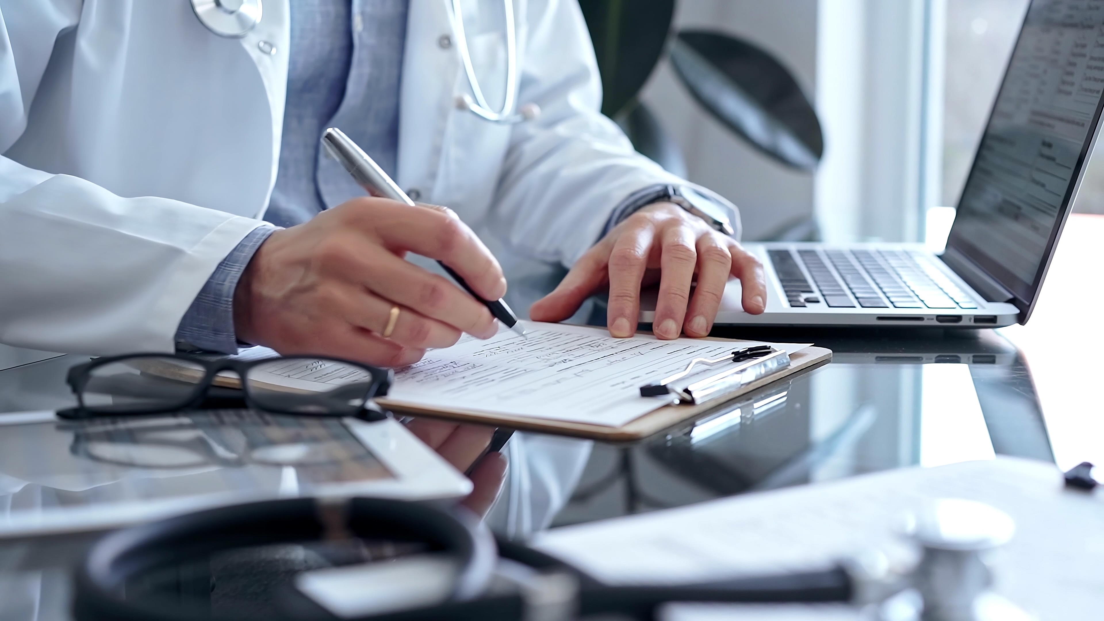 Clinician reviewing patient documentation in an acute care hospital implementing DNV NIAHO® accreditation standards