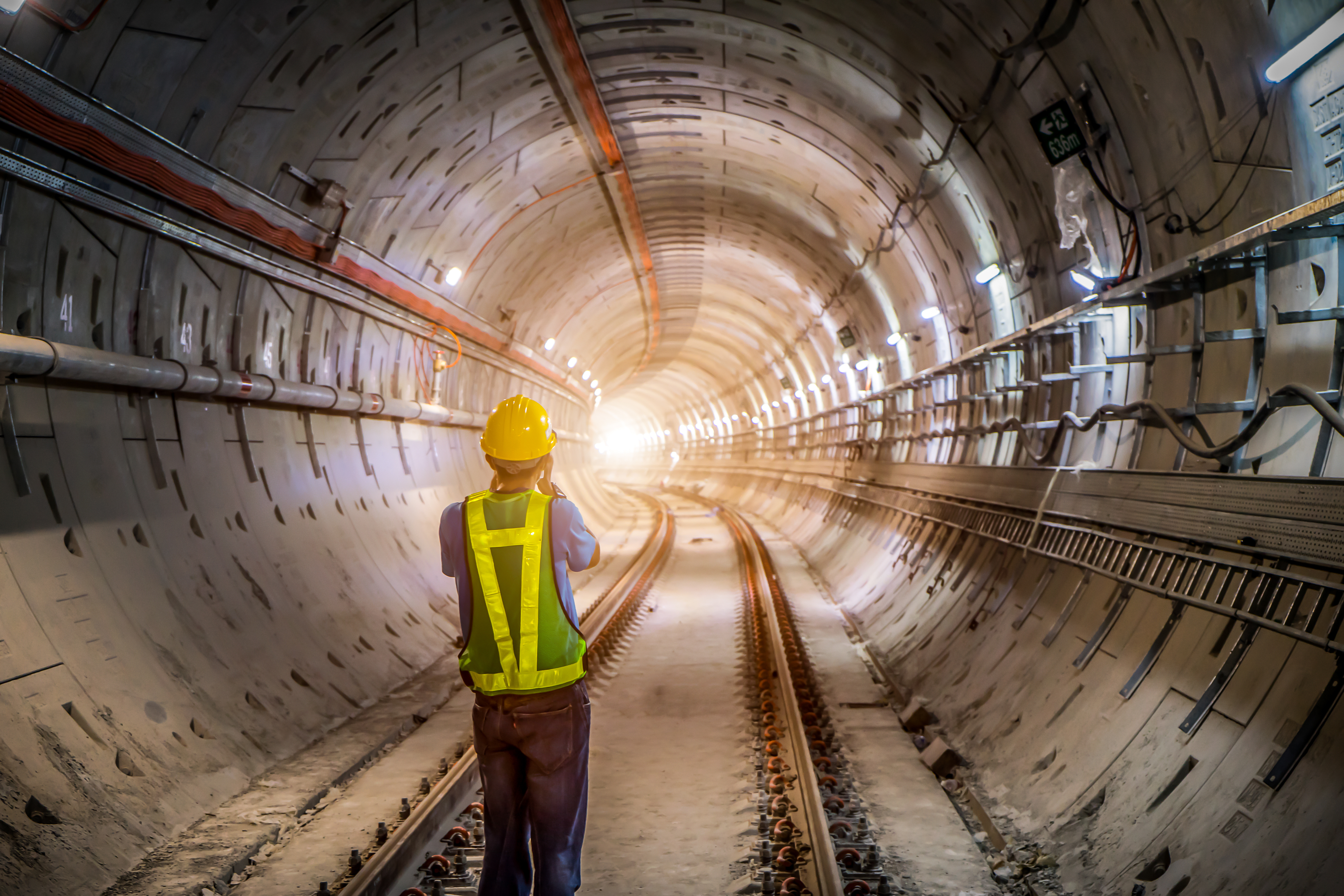 Engineer conducting infrastructure inspection inside a railway tunnel, demonstrating safety, compliance and reliable project delivery