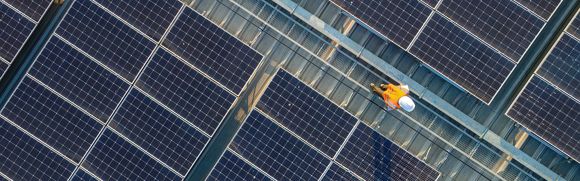 Aerial view of engineer working on a solar panel roof