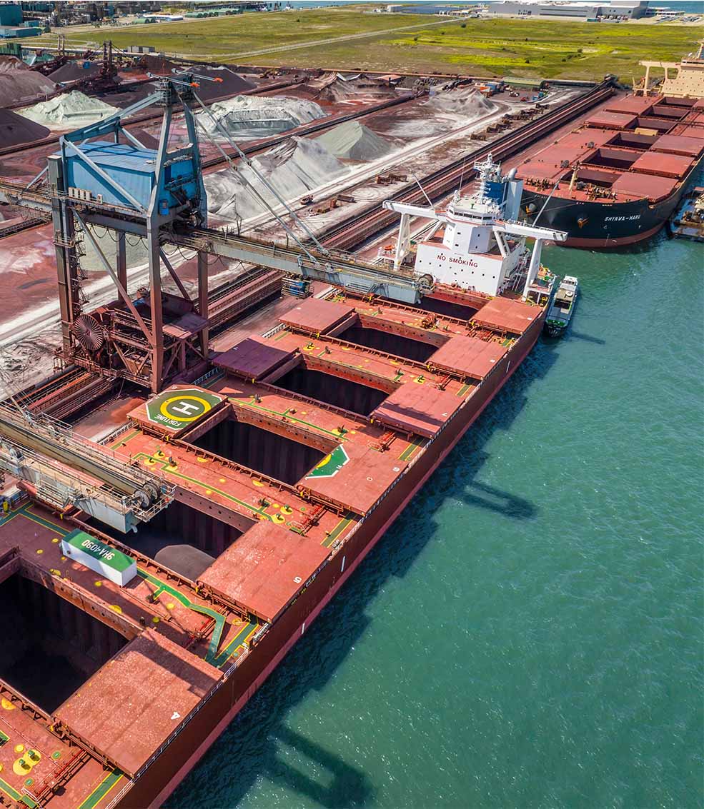 Bulk carrier loading iron ore at port