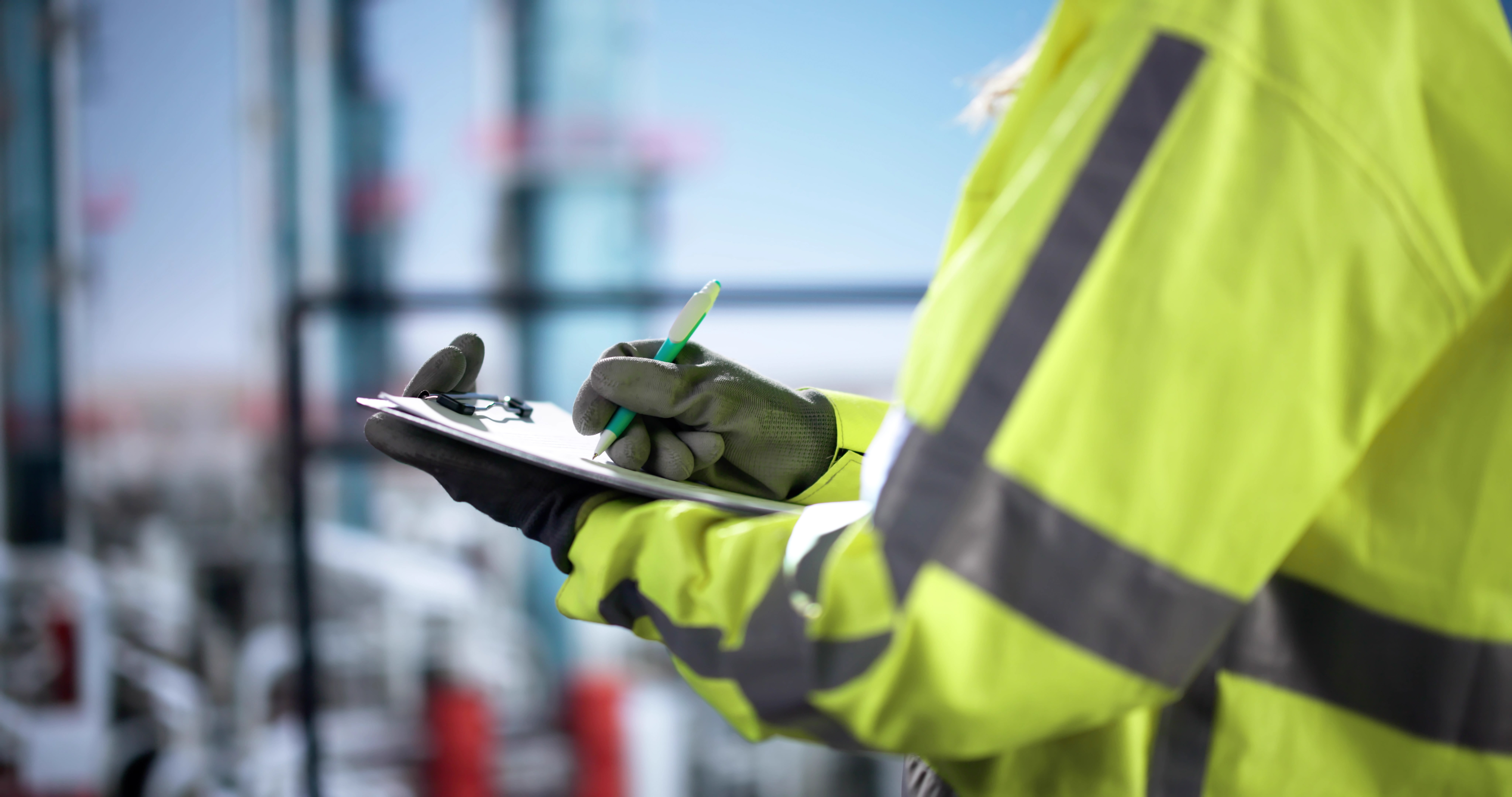 Engineer reviewing emissions or sustainability data on-site, representing SBTi reporting, verification, and climate accountability.
