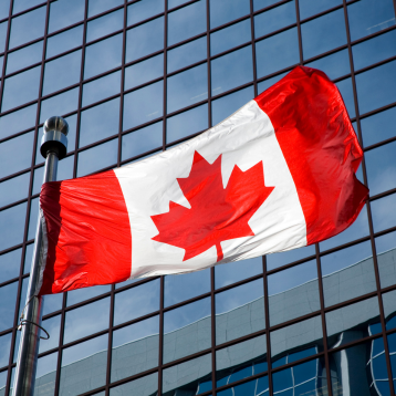Canada flag with building behind