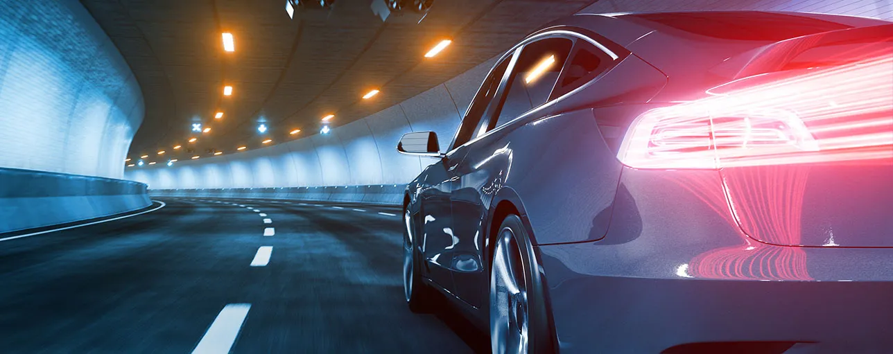 Modern electric car rides through tunnel