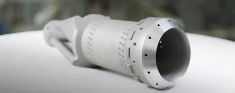 A 3D-printed burner-front with about 8700 layers of high-temperature Nickel-superalloy. The printing process takes about a week and is performed in a L-PBF machine with a quadruple laser system designed for serial manufacturing. The advanced geometrical shapes possible with 3D-printing are particularly valuable for improved mixing of fuels and air, as well as for better cooling of the flame-exposed surfaces.