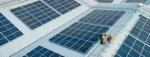 workers installing solar panels
