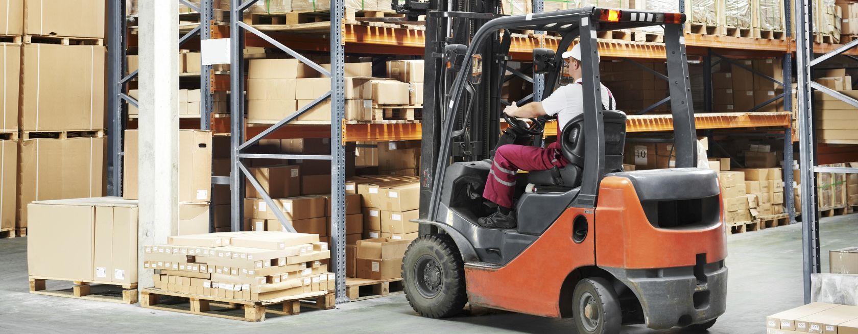 Worker driver at warehouse forklift loader works