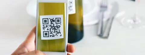 Woman scanning QR code with mobile phone
