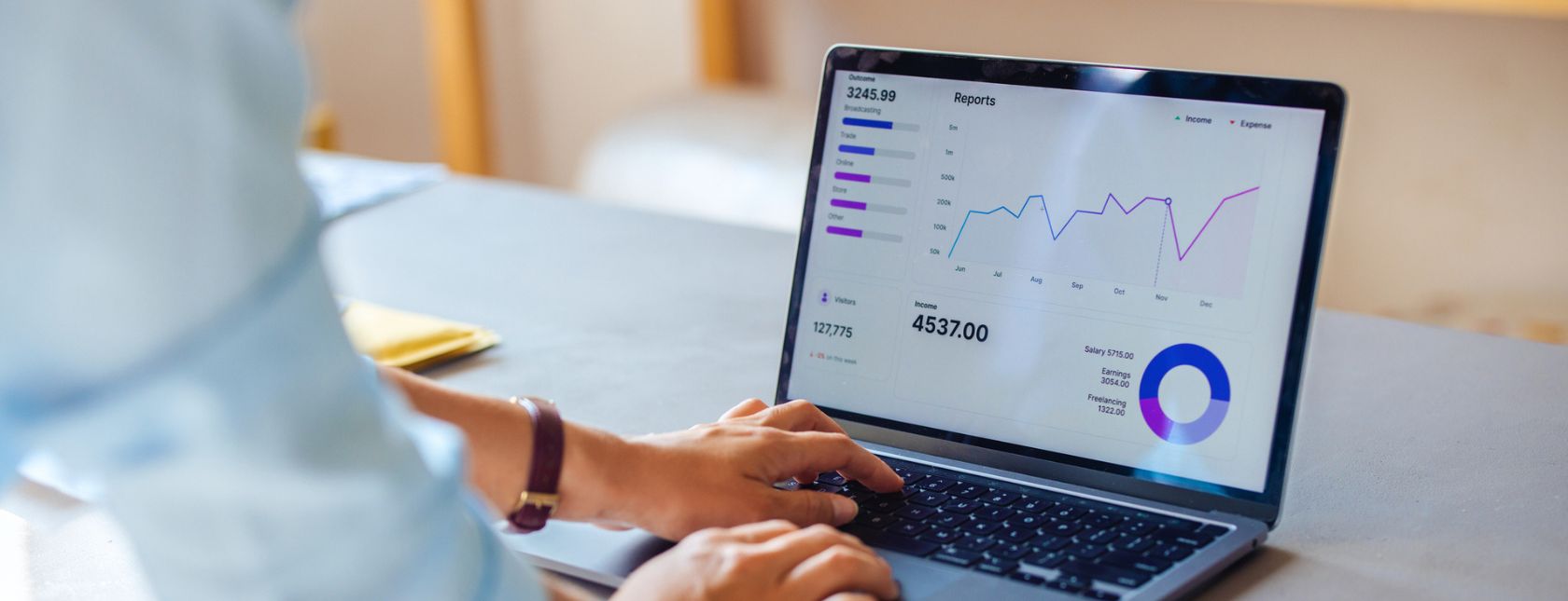 Business professional analyzing financial data on a laptop