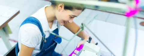 Worker in an factory sewing