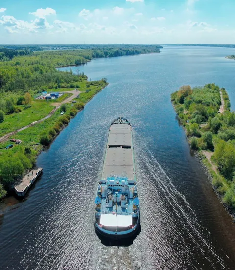 Small container_ship_sailing_through_Canal