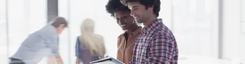 Happy people looking at tablet