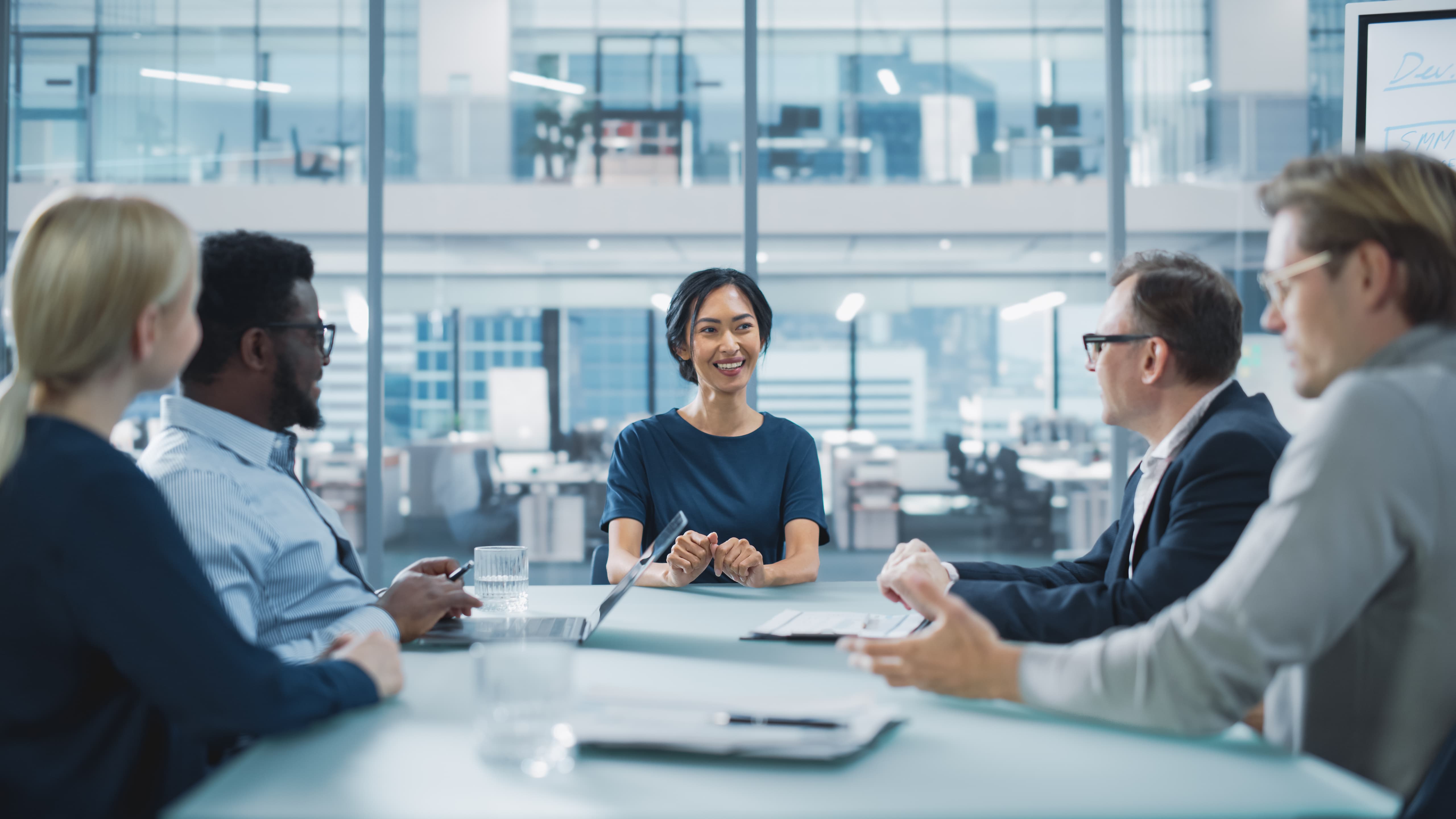 Corporate Meeting Room: Confident Female Executive Director Makes a Report to a Members of the Board and Investors about Company’s Achievement of Record Breaking Annual Revenue