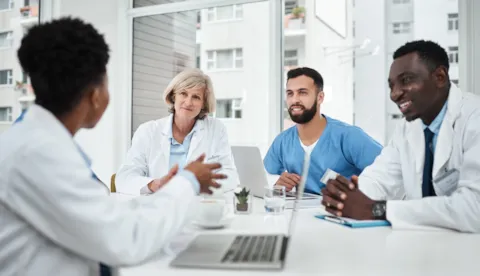 four healthcare workers in conversation
