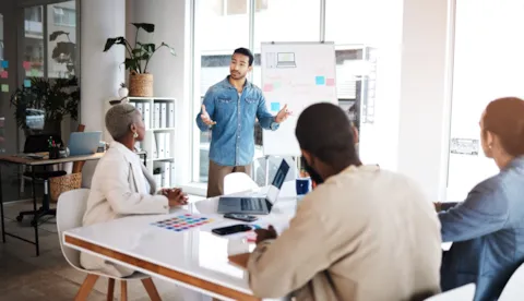four colleagues in modern office space