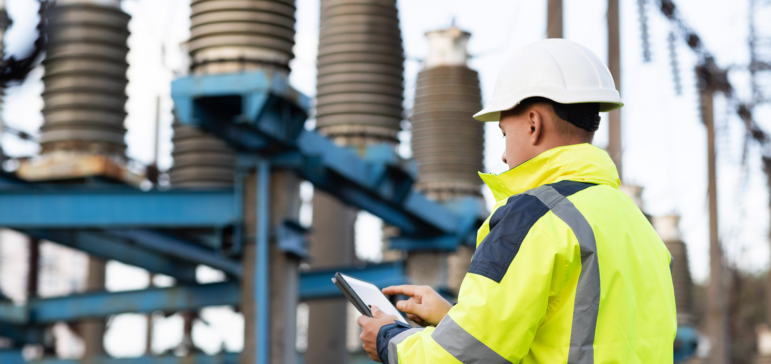 Electrical engineer studying reading on tablet