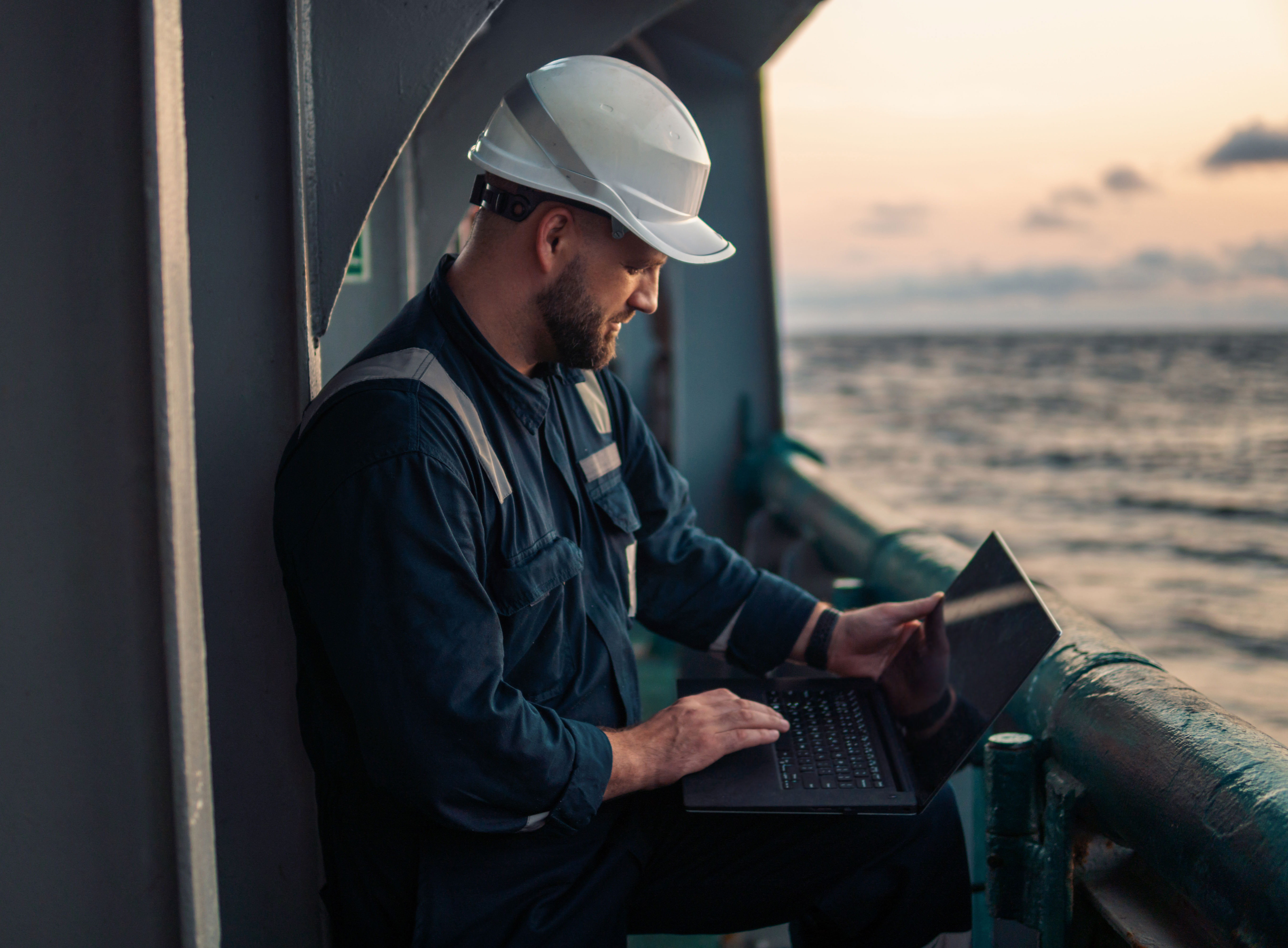 Man offshore working on laptop