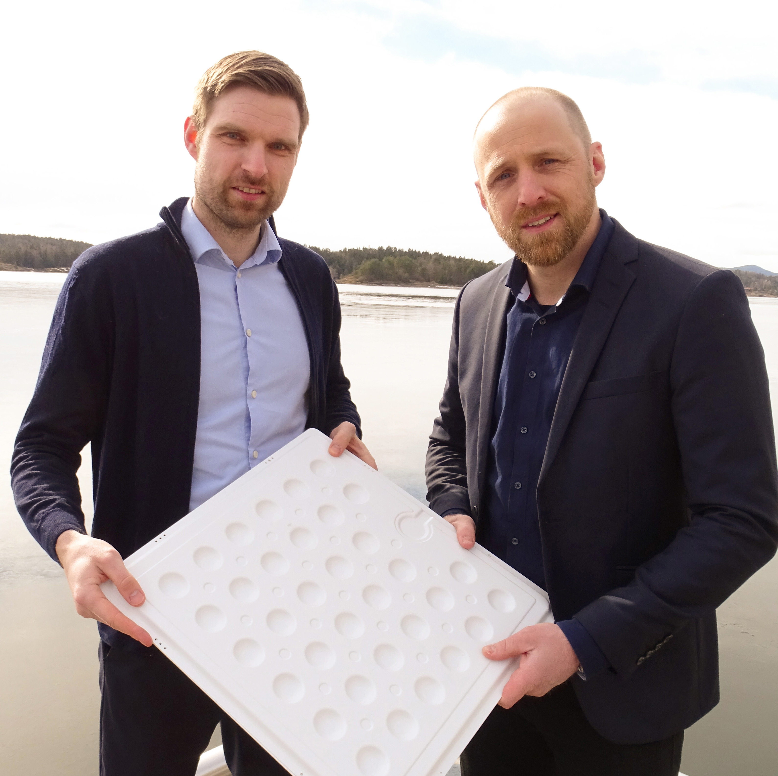 DNV project manager Tore Hordvik (left) and Sunlit Sea CTO Bjørn Hervold Riise (right) with a model of the Sunlit Sea aluminum sheet