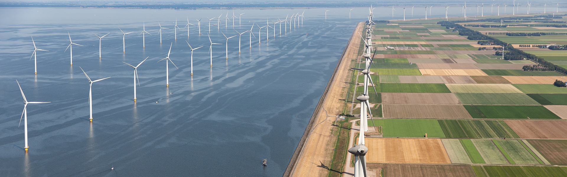 Aerial view of landscape with offshore turbines along the coast