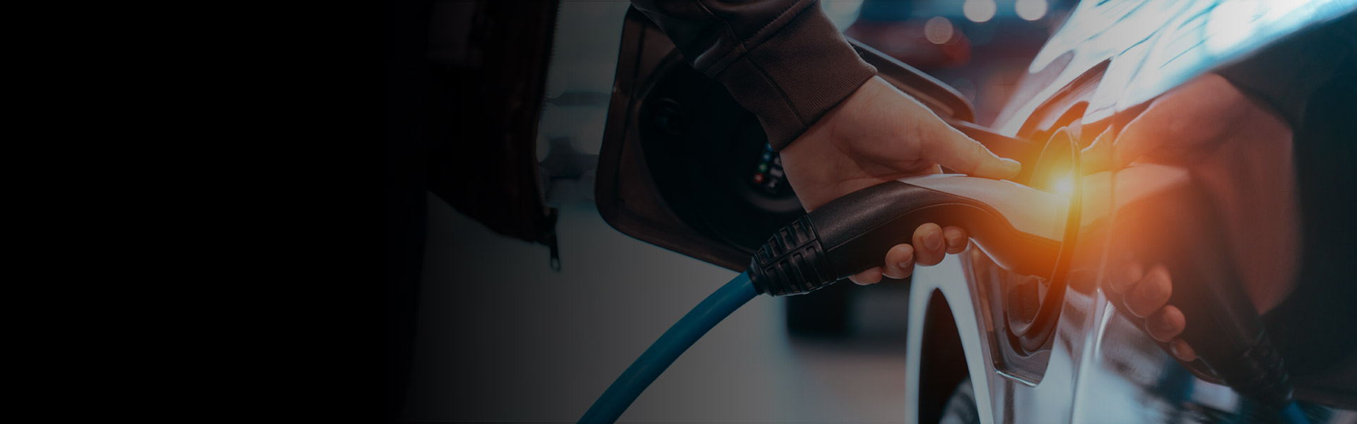 An electric fleet vehicle plugged in to charge.