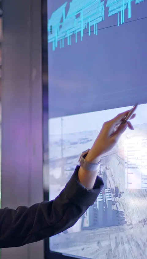 Woman pointing at data on whiteboard