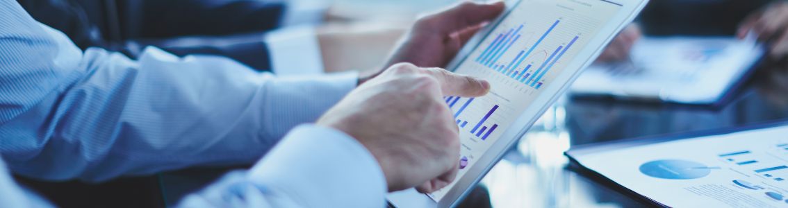 Hand pointing at a document assessing business risks