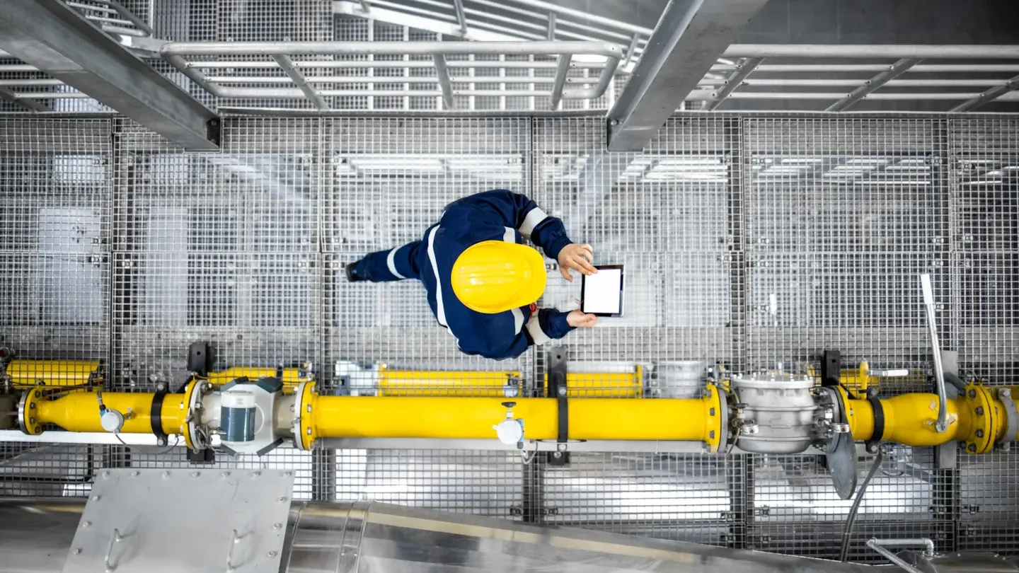 Technician inspecting and testing industrial pressure equipment systems, demonstrating validated repair processes and safety compliance