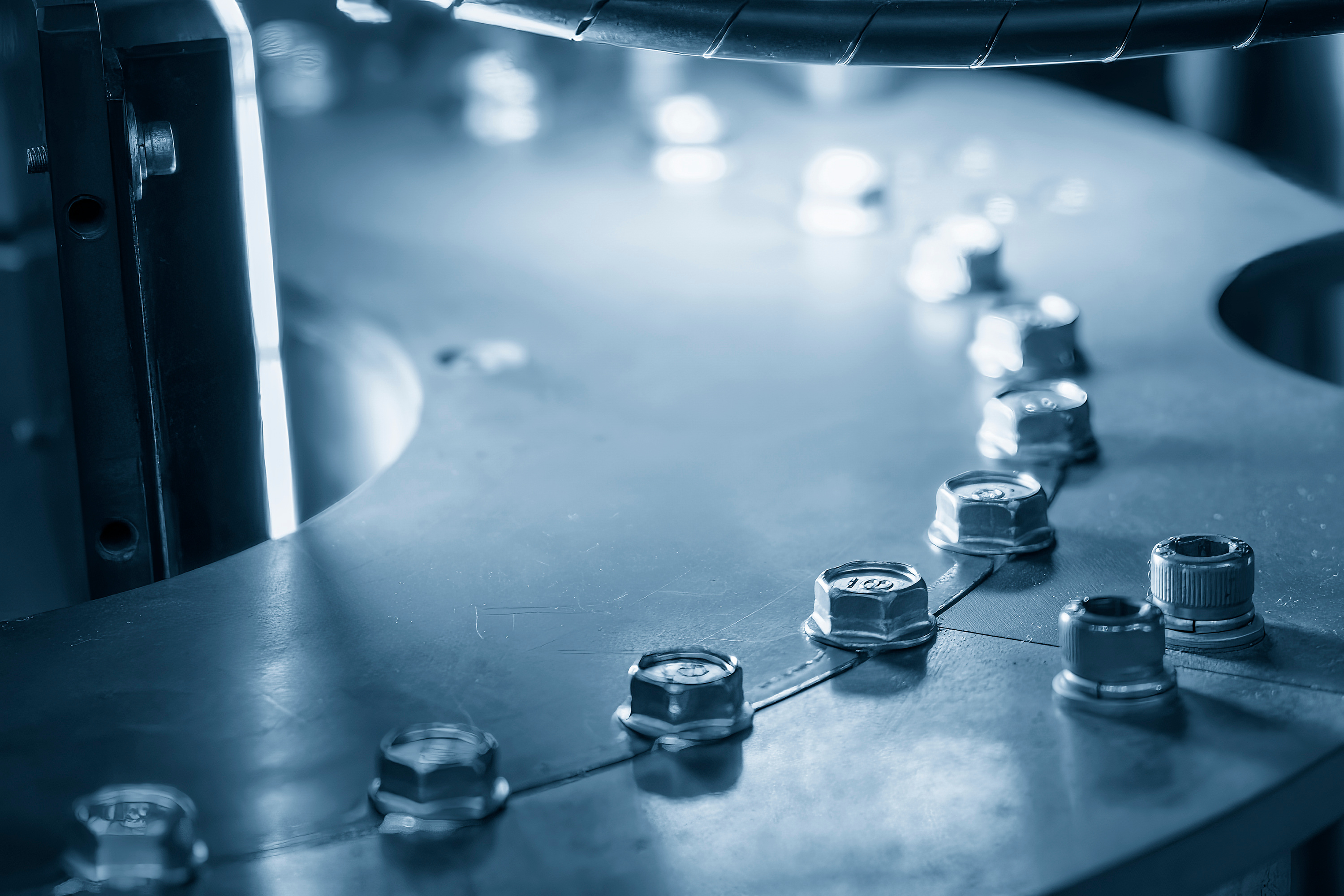 Engineers performing industrial product testing and assurance to verify quality, safety and compliance.