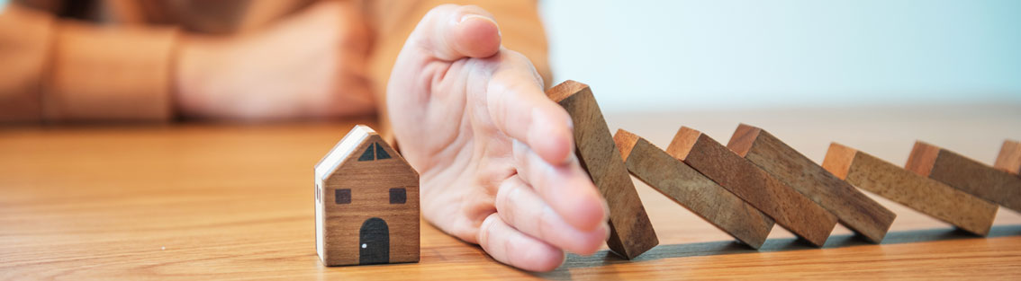 hand protecting from brick falling