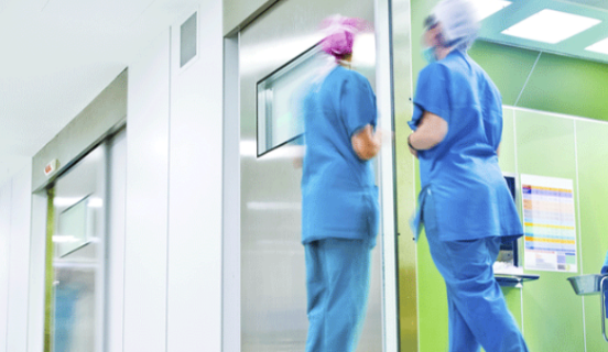 Medical staff walking through a hospital corridor, symbolising medical device manufacturing, healthcare operations, and ISO 13485 compliance needs