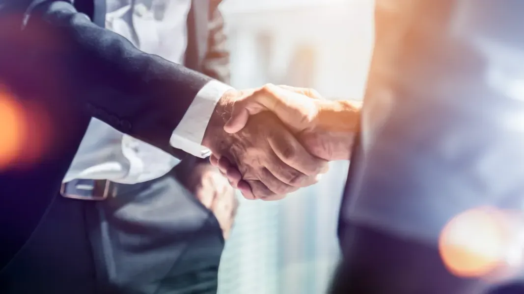 Close-up of a handshake symbolizing trusted partnerships and verification support for land-based aquaculture operations