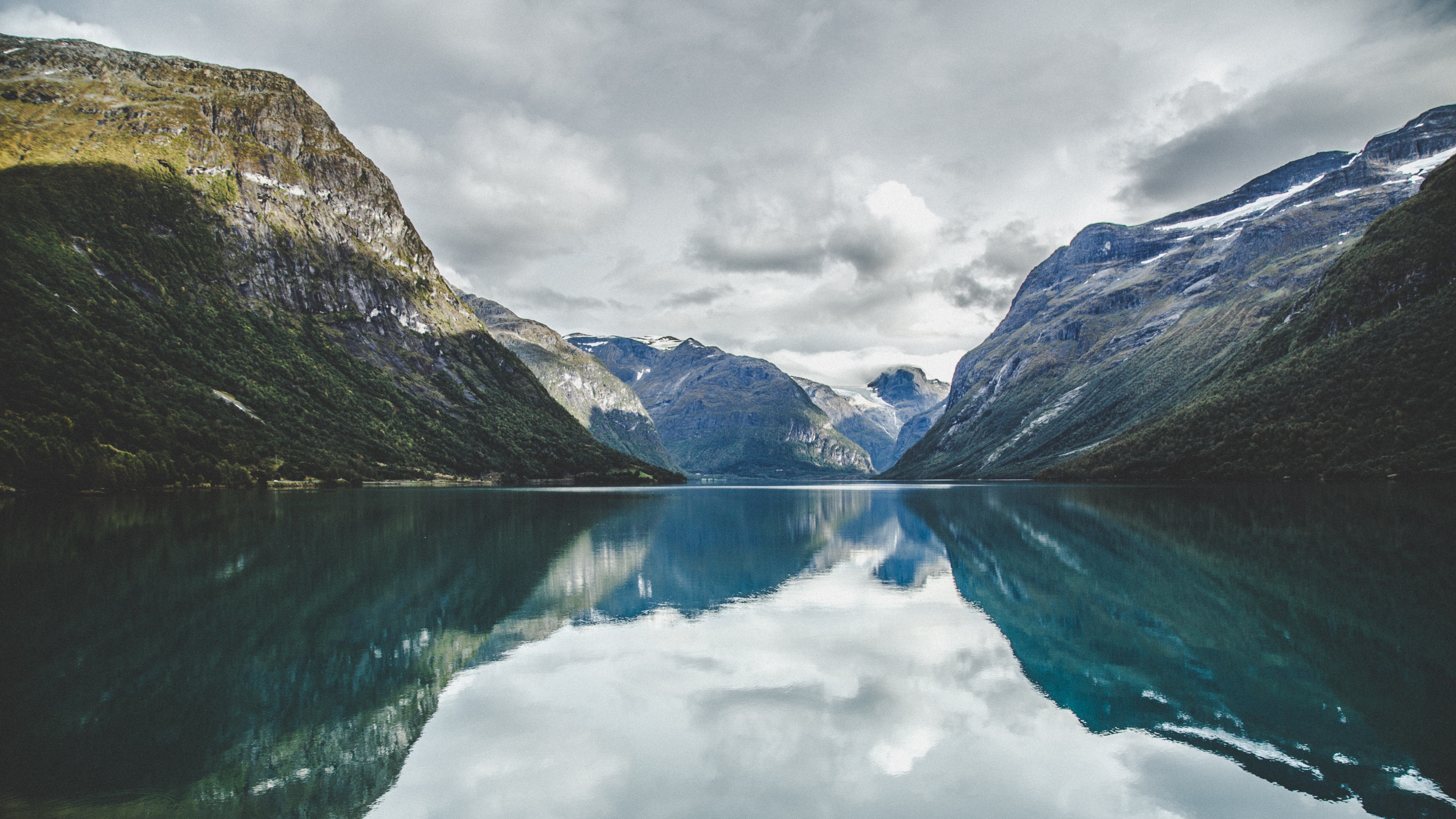 Mountain fjord ecosystem landscape with calm water reflecting surrounding environment