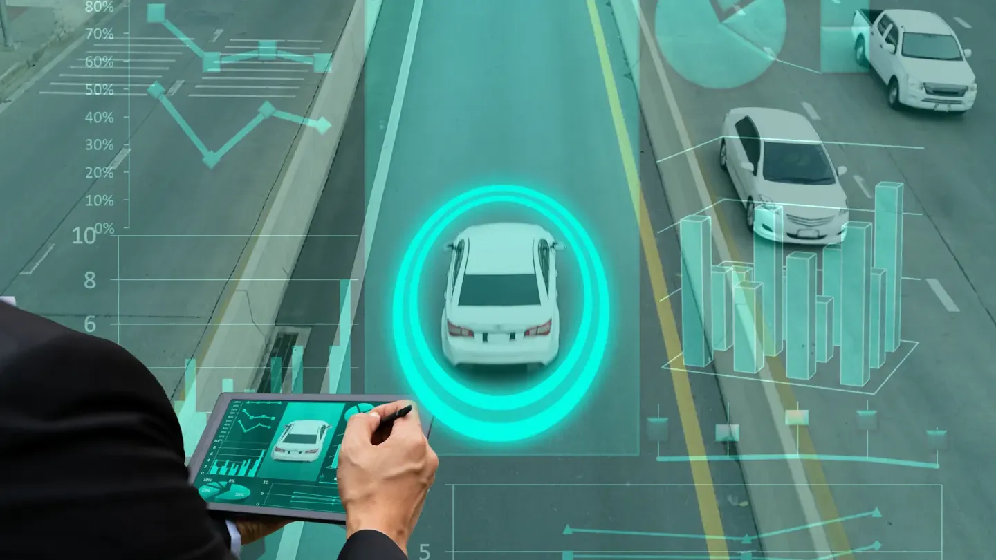 Engineer using a digital interface to analyse vehicle network security and assess cyber threats across connected automotive systems
