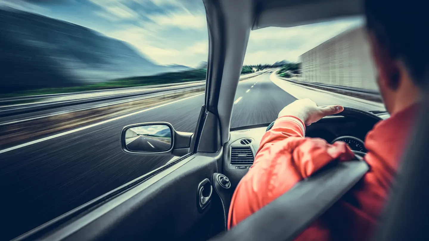 Driver navigating a car through a rural road, representing improved software performance and ASPICE-aligned development processes