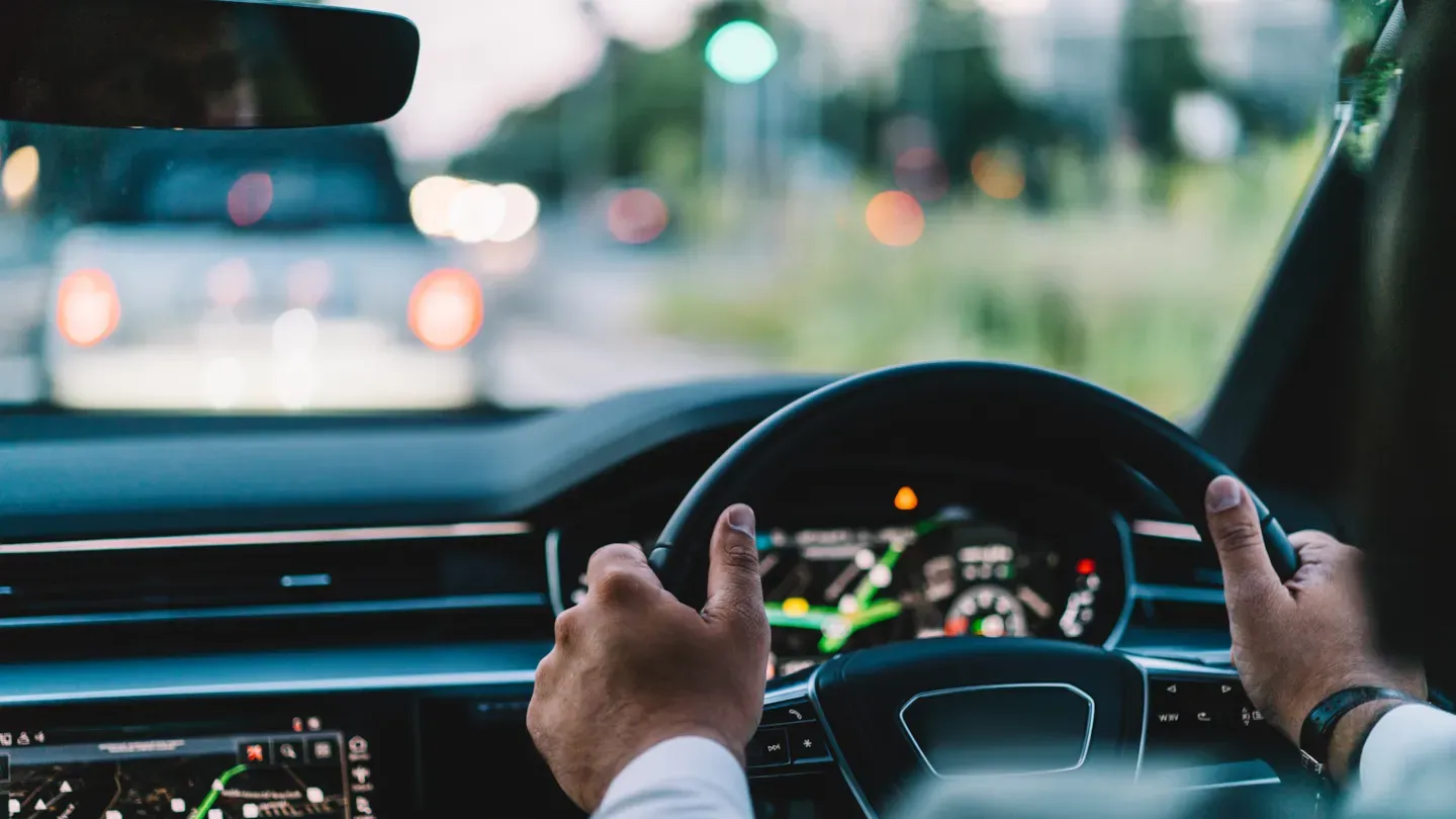 Driver operating a vehicle on the road, symbolising real-world performance assessment and functional safety validation