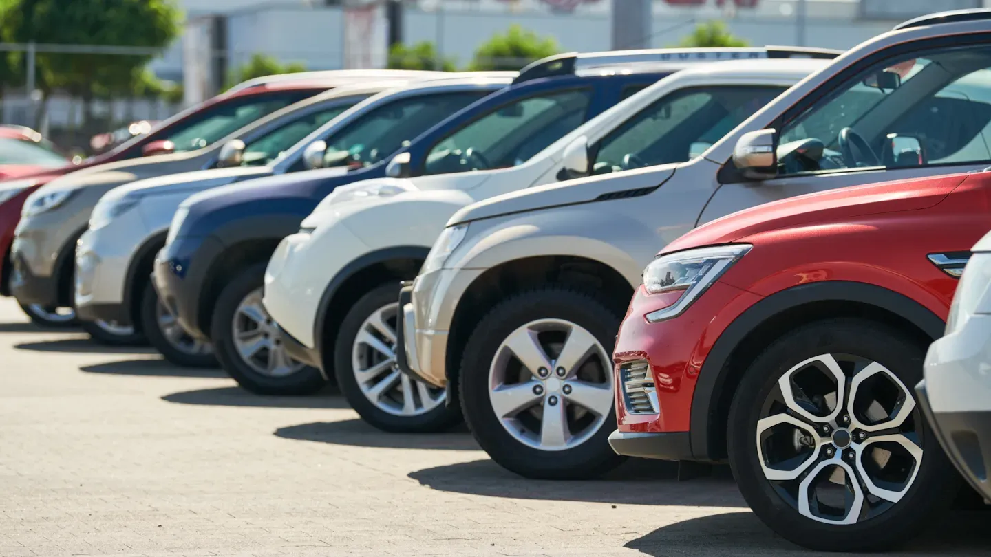 Row of parked vehicles in an outdoor lot, symbolizing safety goal definition and lifecycle-ready automotive concept development